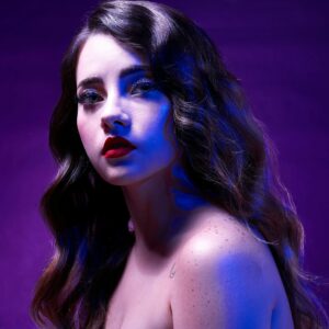 Beautiful portrait of a woman with elegant lighting casting dramatic shadows.